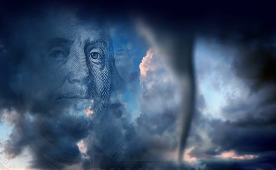 conceptual finance image of money, one hundred dollar bill, and stormy sky with approaching tornado