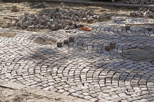 Old style laying cobblestone street pavement
