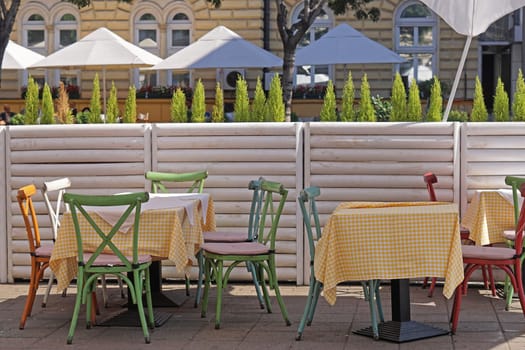Cafe tables and chairs at city street outdoor