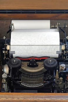Typewriter machine with white paper in roll