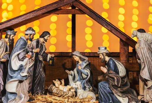 Christmas Manger scene with figurines including Jesus, Mary, Joseph, sheep and magi.
