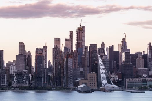 New York City midtown Manhattan sunset skyline panorama view from Boulevard East Old Glory Park over Hudson River.