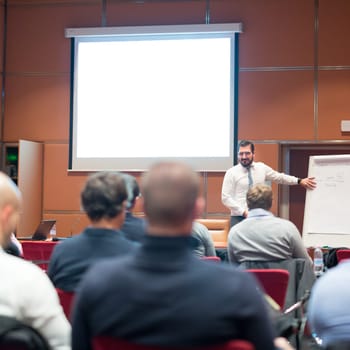 Speaker Giving a Talk at Business Meeting. Audience in the conference hall. Business and Entrepreneurship concept.