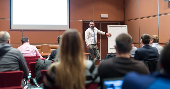 Speaker Giving a Talk at Business Meeting. Audience in the conference hall. Business and Entrepreneurship concept.