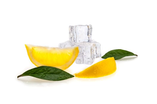 Cubes of cold ice, two slices of fresh yellow lemon and green leaves on white isolated background.
