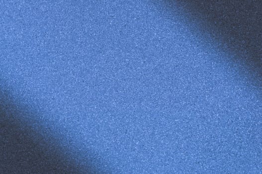 Granite background with blue color with small dots. Darkening left and right diagonally. Blurred.