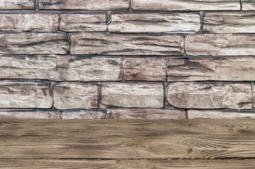 The background is a wall of brown bricks and wooden boards.