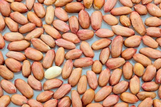 Background of peeled peanuts on a white table close-up