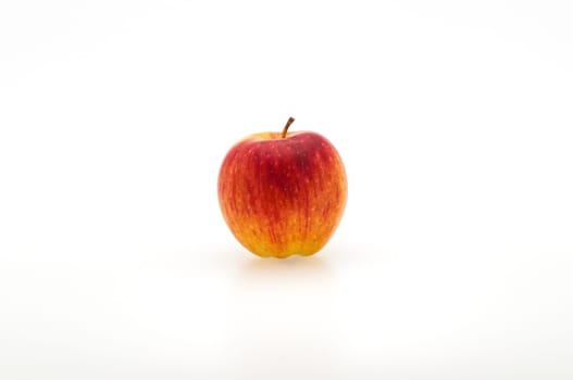 Single fresh red apple. Isolated on white background. Close-up. Studio photography.