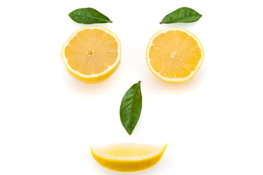 Lemon slices and green leaves in the form of a face. The concept of a healthy lifestyle.