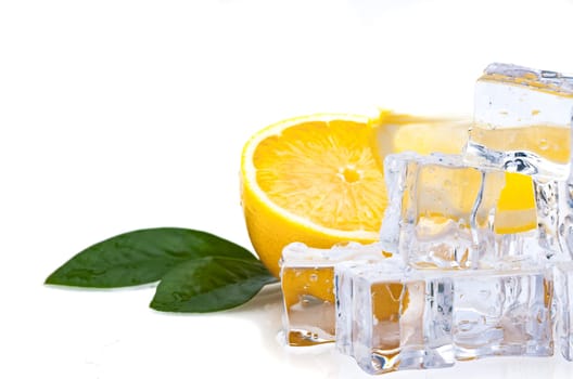 Half of a fresh, bright lemon with green leaves and cubes of cold ice, on a white background.