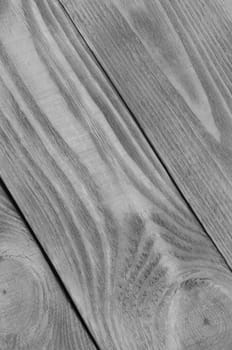 Black and white background from boards of light wood arranged diagonally