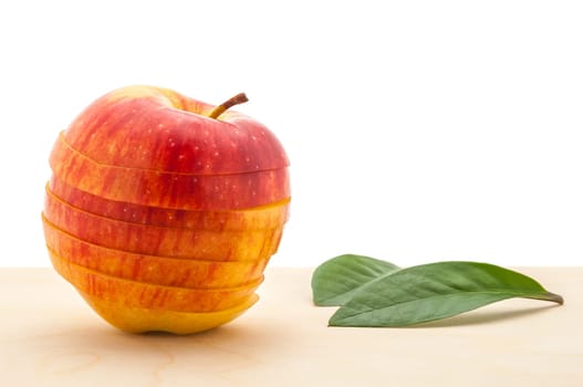 apple preserved its shape, but cut into slices on a wooden table.