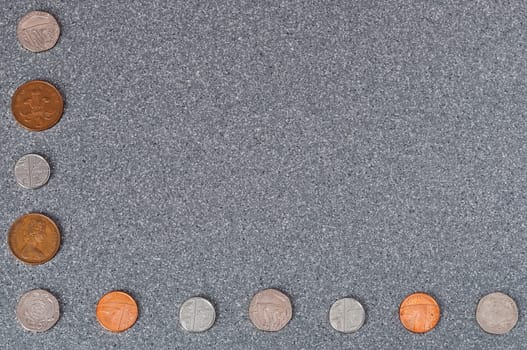 Coins of Great Britain of the background of gray granite.