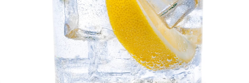 In the jug is a drink of ice, the lobules of a fresh juicy lemon and crystal clear water.