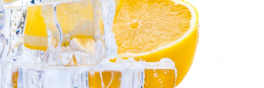 Cubes of cold ice, and halves of fresh, bright juicy lemon on a white background.