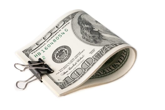 The American dollar bills are folded and clamped with a paper clip. on white background.