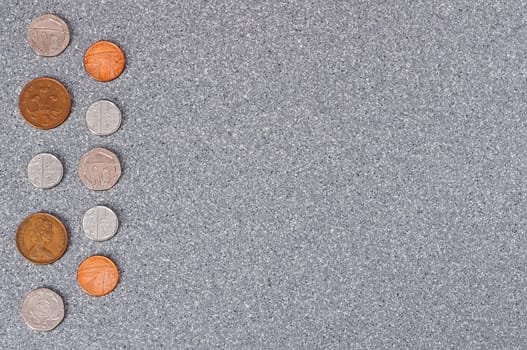 Coins of Great Britain on a background of granite.
