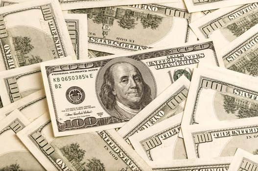 A background of one hundred dollar bills in a vintage style.