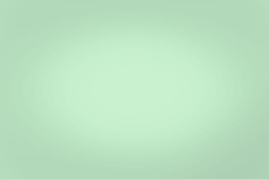 Blurred background light green color. Enlightenment in the center. No texture.