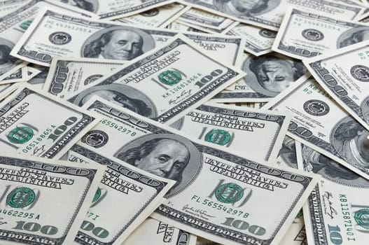 A pile of one hundred US banknotes. Cash of hundred dollar bills, dollar background image.