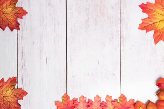 Frame of autumn. Top view on autumn frame of multi-colored autumn leaves on a wooden board with copy space.