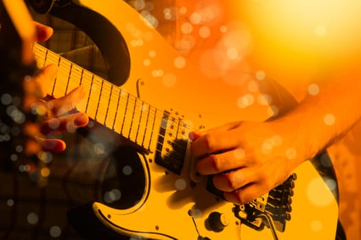 Life style image of close up young male guitarist hand, playing electric guitar