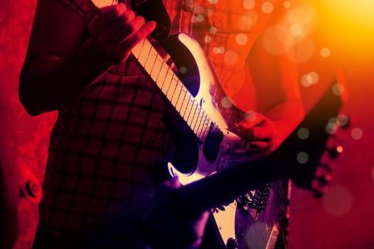 Life style image of close up young male guitarist hand, playing electric guitar