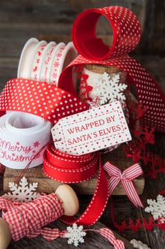 Cheerful ribbons for wrapping Christmas presents in front off wooden background