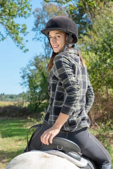 a portrait of beautiful girl on horseback