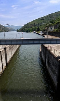View of the canal connecting the lock to the upstream of the Douro River on the Regua Dam, also called Bagauste Dam, Portugal