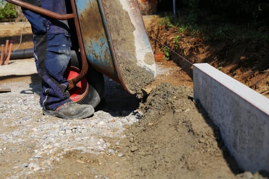 Exploring and concreting a curb on the construction site.