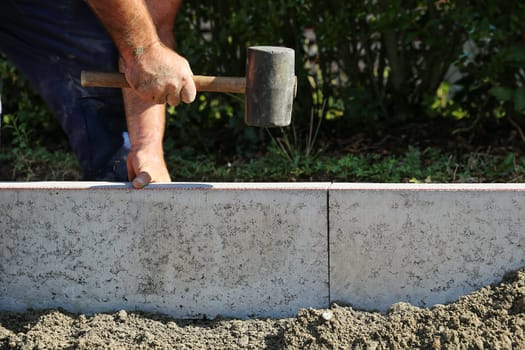 Exploring and concreting a curb on the construction site.