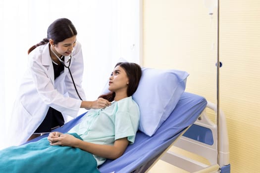 Asian Doctor make routine health check with patient in hospital ward