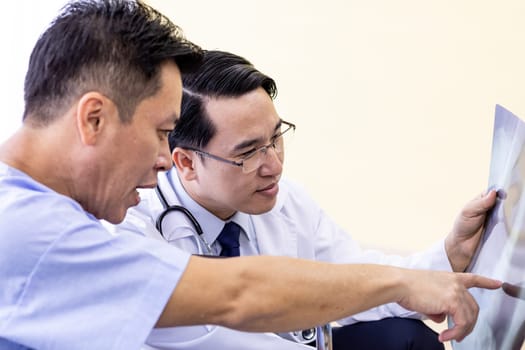 Doctor explaining x-ray results to senior patient and his relative