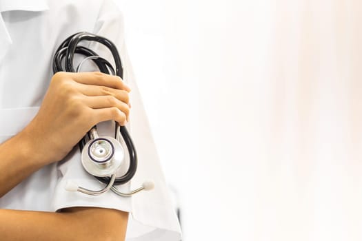 Female Doctor holding stethoscope with copyspace