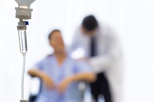 Set iv fluid intravenous drop saline drip in hospital room with patient and doctor in background