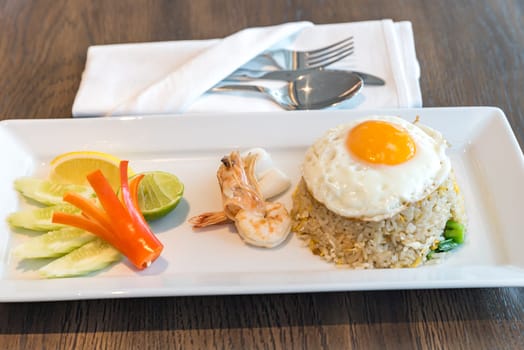 Seafood fried rice with squid and shrimp top with fried egg