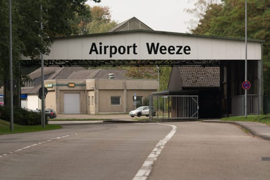 WEEZE, NRW, GERMANY - SEPTEMBER 10, 2018:.Militärisch ausehende Zufahrt zum Flughafengelände Weeze mit alten Kasernengebäuden ..WEEZE, NRW, GERMANY - SEPTEMBER 10, 2018:.Military outward access to Weeze Airport with old barracks buildings
