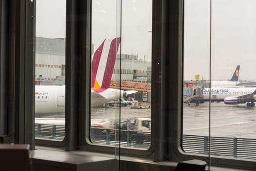 DUESSELDORF, NRW, GERMANY - FEBRUARY 20, 2017: Aircraft on the runway of different airlines at the gates of the International Airport in Duesseldorf, Germany. They are ready for boarding and refueling..