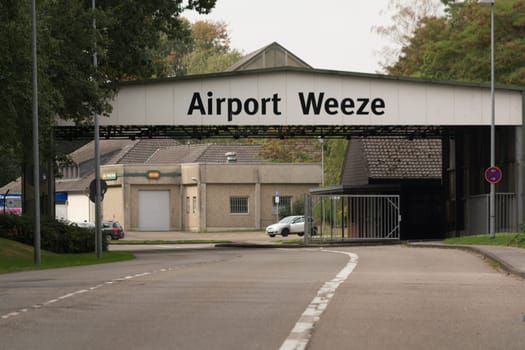 WEEZE, NRW, GERMANY - SEPTEMBER 10, 2018:.Militärisch ausehende Zufahrt zum Flughafengelände Weeze mit alten Kasernengebäuden ..WEEZE, NRW, GERMANY - SEPTEMBER 10, 2018:.Military outward access to Weeze Airport with old barracks buildings