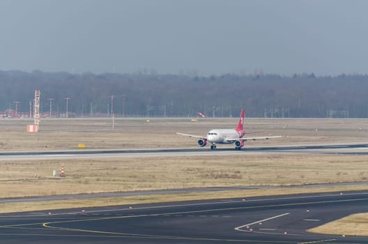 Dusseldorf, Nrw, Germany - March 18, 2015: Up, Airplane Dusseldorf. View of the tarmac. Large passenger airplane at the gate.