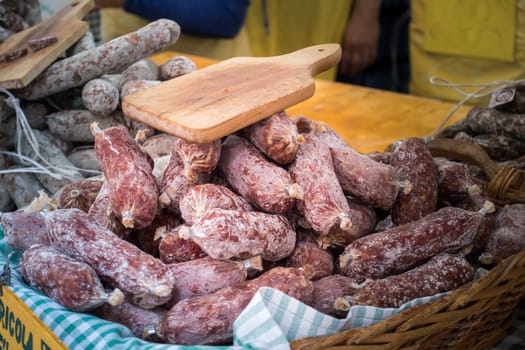 Many salamis  for sale at the local market in Italy
