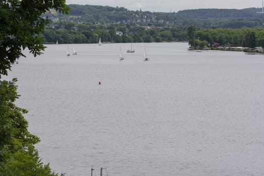 ESSEN, NRW, GERMANY - JUNE 10, 2017:.Panoramic view from Baldeney Lake (Baldeneysee). In the background sailing boats at a sailing regatta..