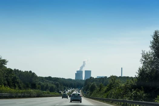UNNA, GERMANY - AUGUST 23, 2017: Traffic on the A2 motorway and Scholven coal power station, Germany, North Rhine-Westphalia.