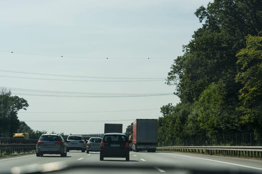 UNNA, GERMANY - AUGUST 23, 2017: Traffic on the A2 motorway and Scholven coal power station, Germany, North Rhine-Westphalia.