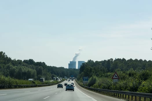 UNNA, GERMANY - AUGUST 23, 2017: Traffic on the A2 motorway and Scholven coal power station, Germany, North Rhine-Westphalia.