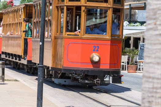 PORT DE SOLLER, SPAIN - JUNE 02, 2016: Vintage train, tram on the beach promenade of the town of Soller in Spain. Opened in 1913, the driving distance is about 5 km long.