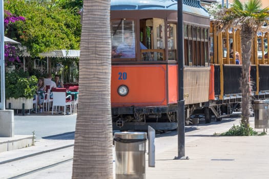 PORT DE SOLLER, SPAIN - JUNE 02, 2016: Vintage train, tram on the beach promenade of the town of Soller in Spain. Opened in 1913, the driving distance is about 5 km long.