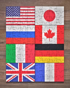 Flags of the G8 member countries in the form of puzzle pieces.